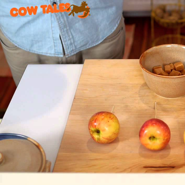 Person standing in front of table preparing some apples for a recipe