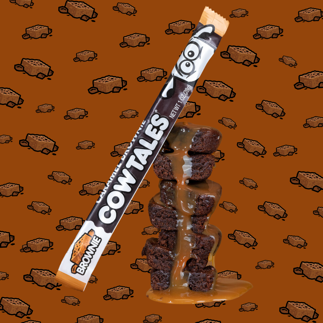 Caramel Brownie Cow Tale® sitting on a stack of caramel covered brownies.