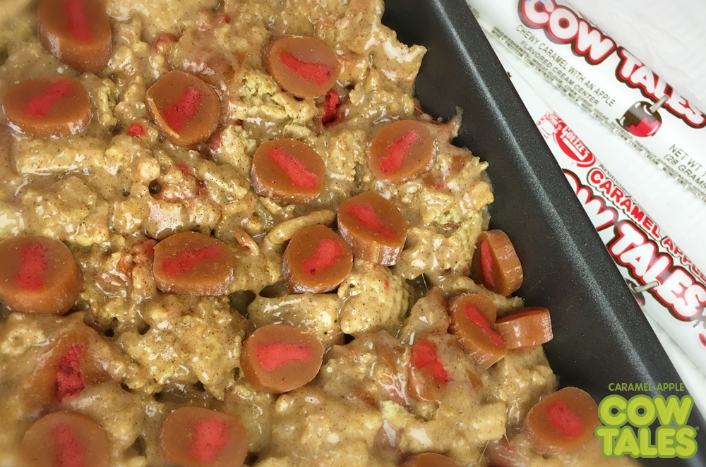 Chopped up Caramel Apple Cow Tales mixed with marshmallows and cinnamon cereal in a pan prepped for the oven