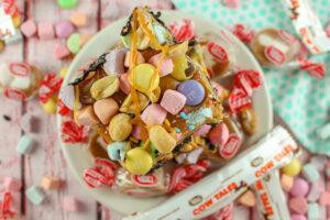 A caramel peanut butter cookie covered in a variety of candy