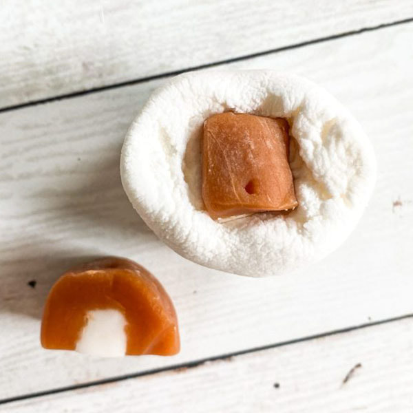 A large Marshmallow with a half of caramel cream stuffed in it